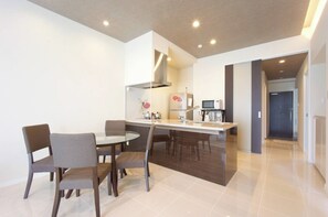 Enjoy meals and social gatherings in this kitchen with a central island, sink, and dining table for four.