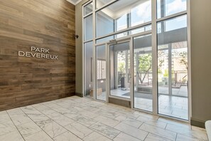 A modern interior with a wooden wall and a sign reading 'PARK DEVEREUX'. - One Bedroom Hideaway w/ free parking steps to Downtown (Raleigh)
