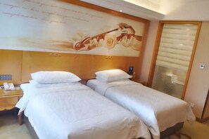A hotel room with two single beds, a wooden headboard, a nightstand with a phone, and a wall with a floral and musical artwork. - Vienna Hotel (Shanghai Chongming Lvhai Road) (Shanghai)