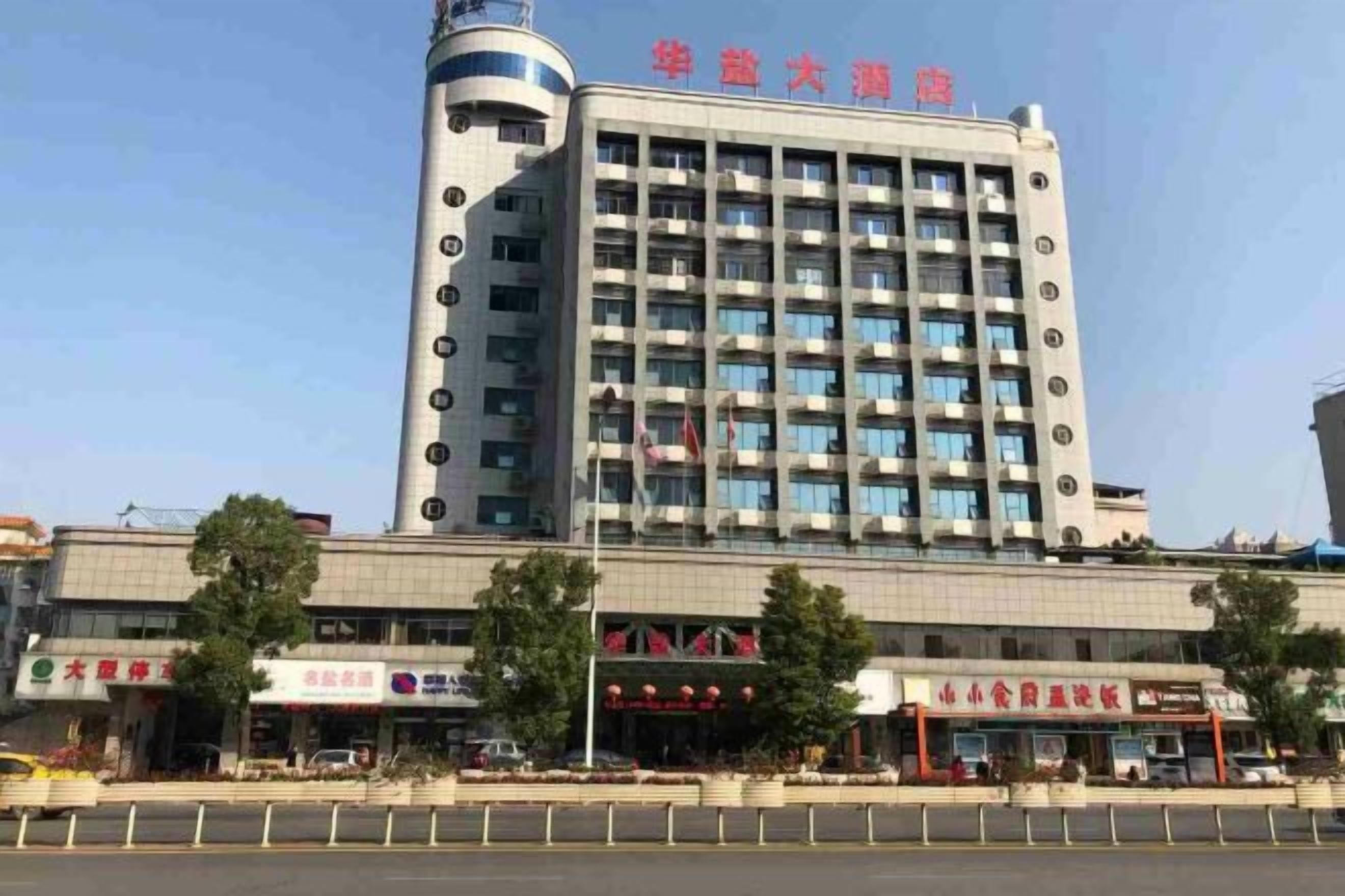 A multi-story hotel with a prominent vertical tower and a flat facade.