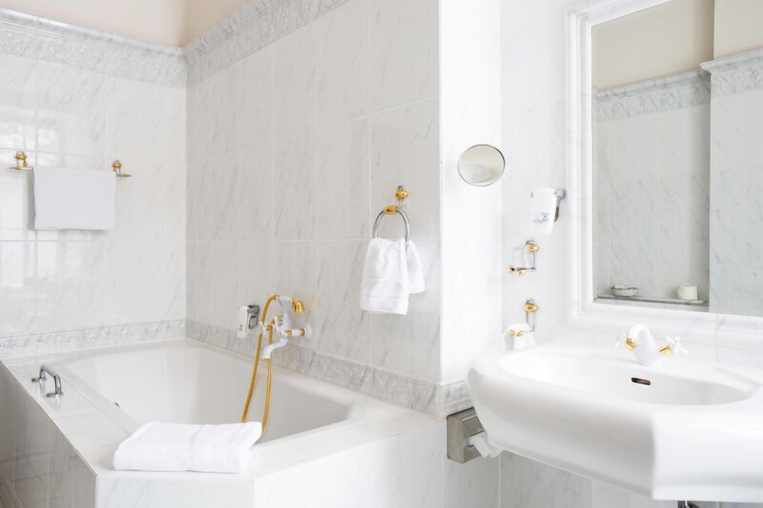Ein modernes Badezimmer mit Badewanne, Waschbecken und Spiegel.