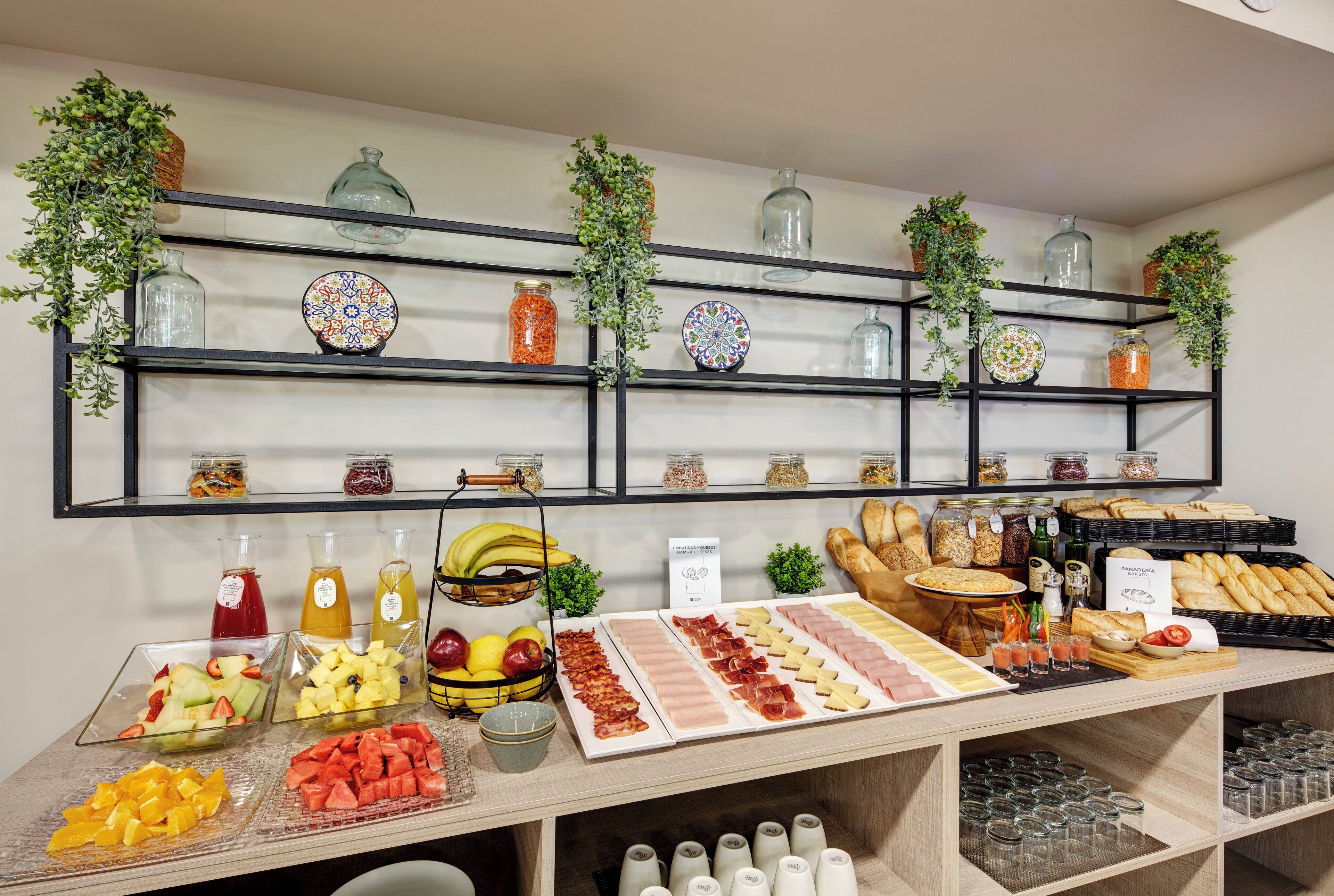 A breakfast buffet with various food items and beverages.
