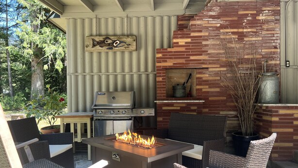 An outdoor patio with a grill, seating, and a fire feature. - Cozy cottage in the woods, sleeps 8, close to Olympic National Park and Lakes (Port Angeles)