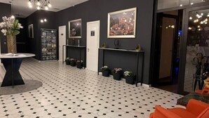 A spacious living area with a black and white tiled floor, a modern chandelier, and a large window. - Bricks Hotel (Tbilisi)
