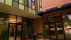 A hotel with a modern glass facade, a brick exterior, and a sign reading 'BRICKS HOTEL'. - Bricks Hotel (Tbilisi)