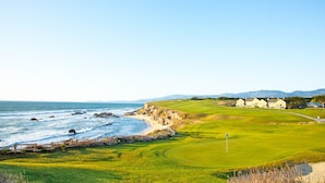 A coastal golf course with a view of the ocean and mountains in the background. - Nantucket Penthouse - walk to restaurants, beaches, activies & so much more (Half Moon Bay)