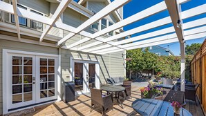 A covered patio with outdoor furniture, a wooden deck, and a white pergola. - Nantucket Penthouse - walk to restaurants, beaches, activies & so much more (Half Moon Bay)