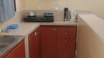 Fridge, stovetop, electric kettle, cookware/dishes/utensils