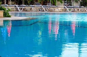 A clear swimming pool with lounge chairs along the edge. - Epic Hotel (Marmaris)