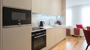 A modern kitchen with a built-in oven, microwave, and coffee maker.