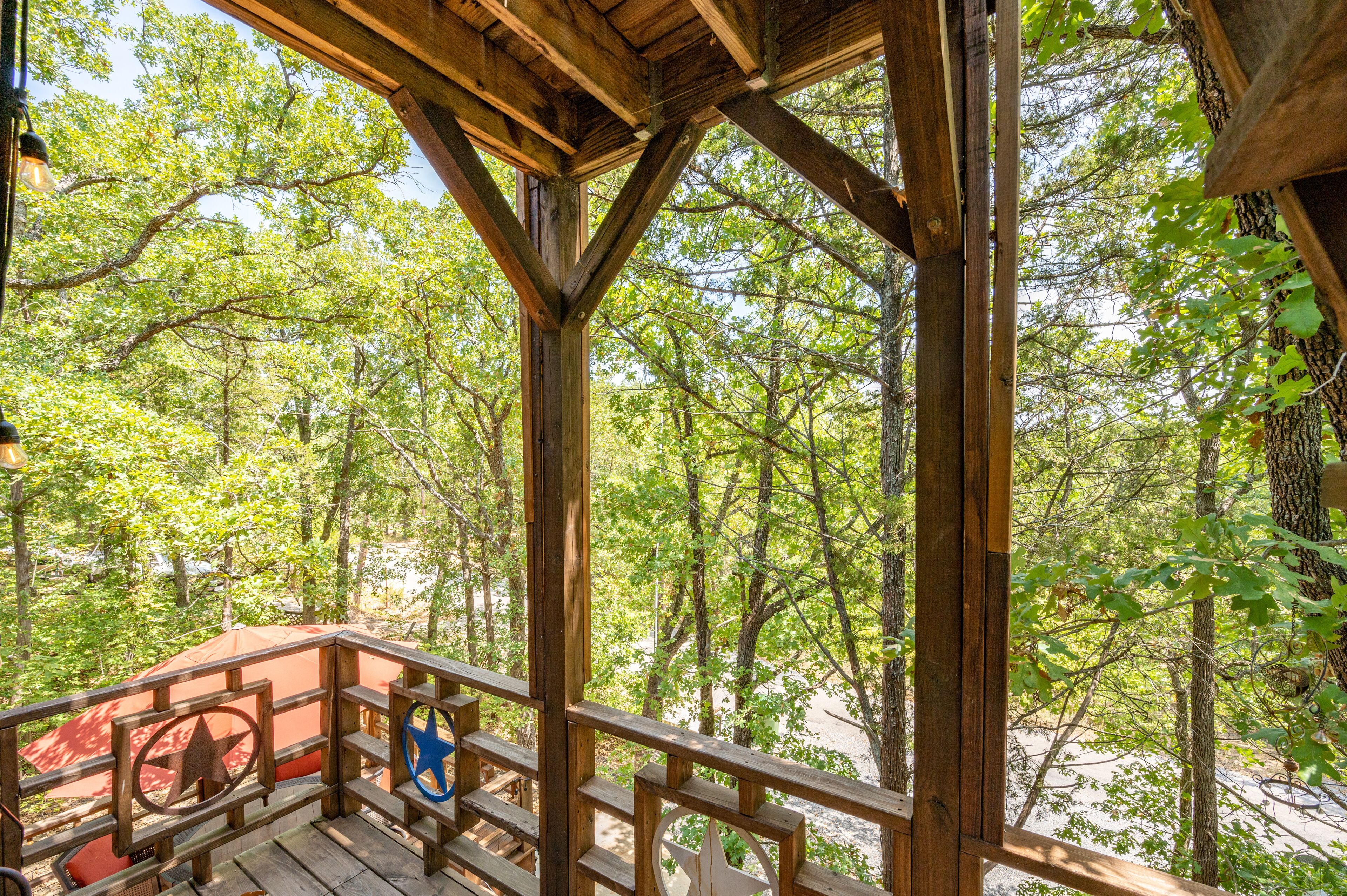 A wooden deck with a view of a forest.