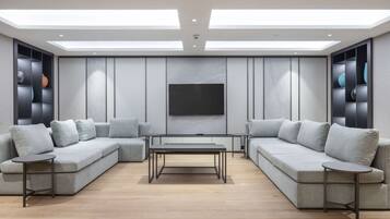 A modern living room with a sectional sofa, a coffee table, and built-in shelving.