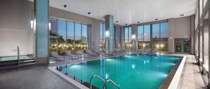 Relax by the pool surrounded by lounge chairs and enjoy a view of the landscaped garden.