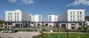 Stunning hotel facade with a symmetrical design, featuring rectangular windows and balconies.
