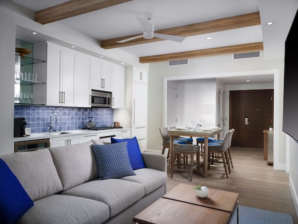 A modern kitchen with white cabinets, a microwave, and a blue-tiled backsplash. - Shore House at The Del, LXR Hotels & Resorts (Coronado)