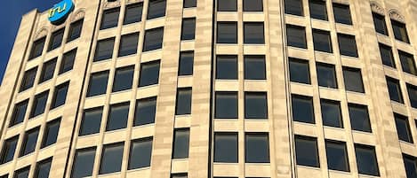 A tall building with a grid of windows and a sign that reads "HOME 2".