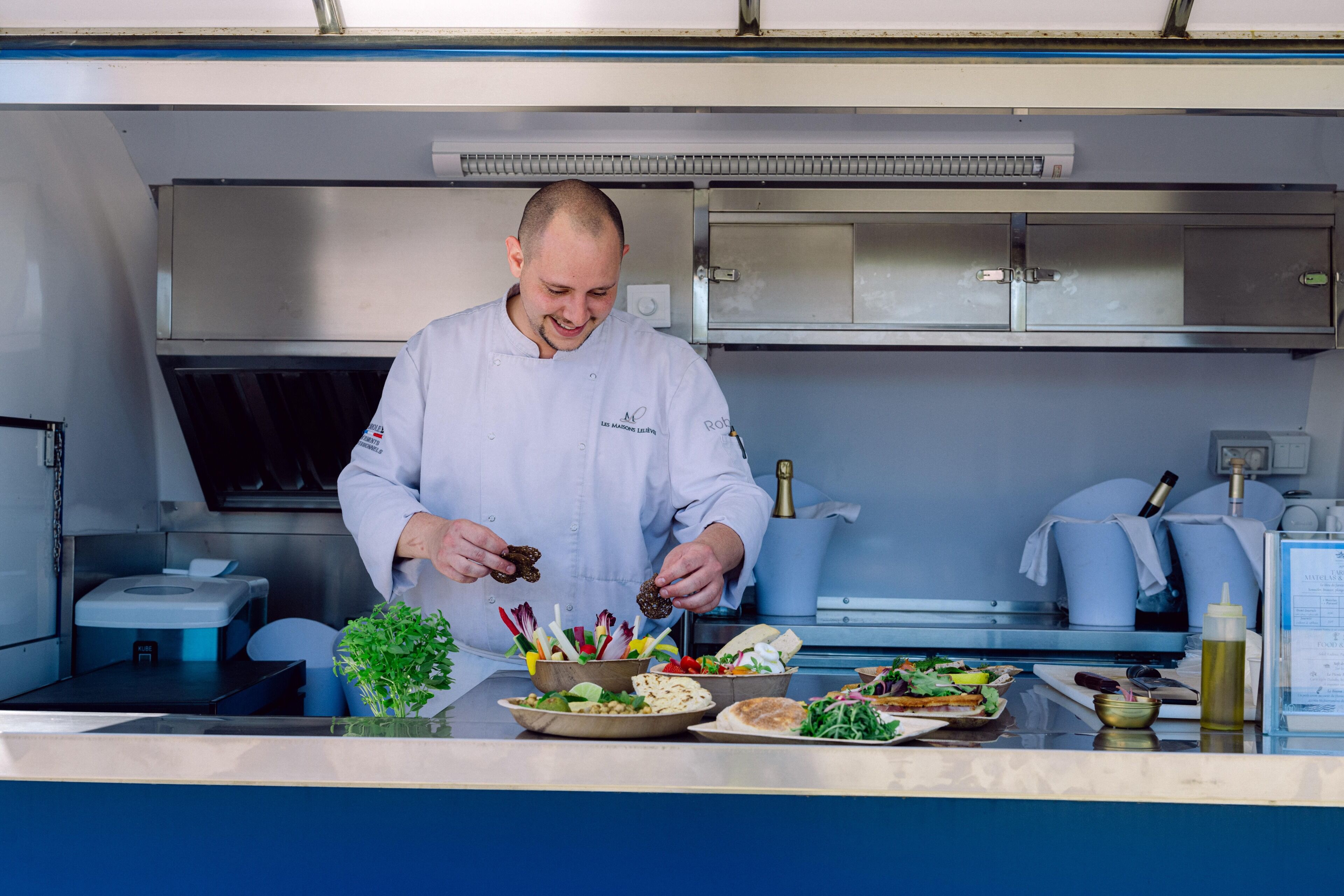 A chef in a professional kitchen preparing food.