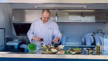 A chef in a professional kitchen preparing food.