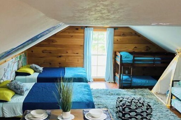 Bunkhouse has open floor plan with 6 beds (2 Queen beds and 4 twin beds)