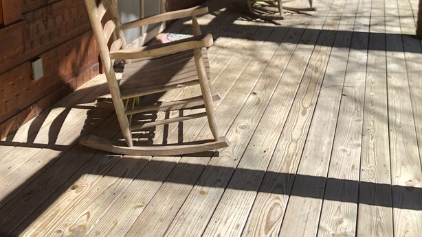 A wooden porch with rocking chairs, a door, and a window. - Cabin #4   Secluded and Quiet (Oneida)
