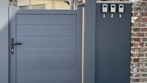 A grey metal gate with a keyhole and a keypad with numbers 1, 2, and 3. - House near nogent sur Seine (Crancey)