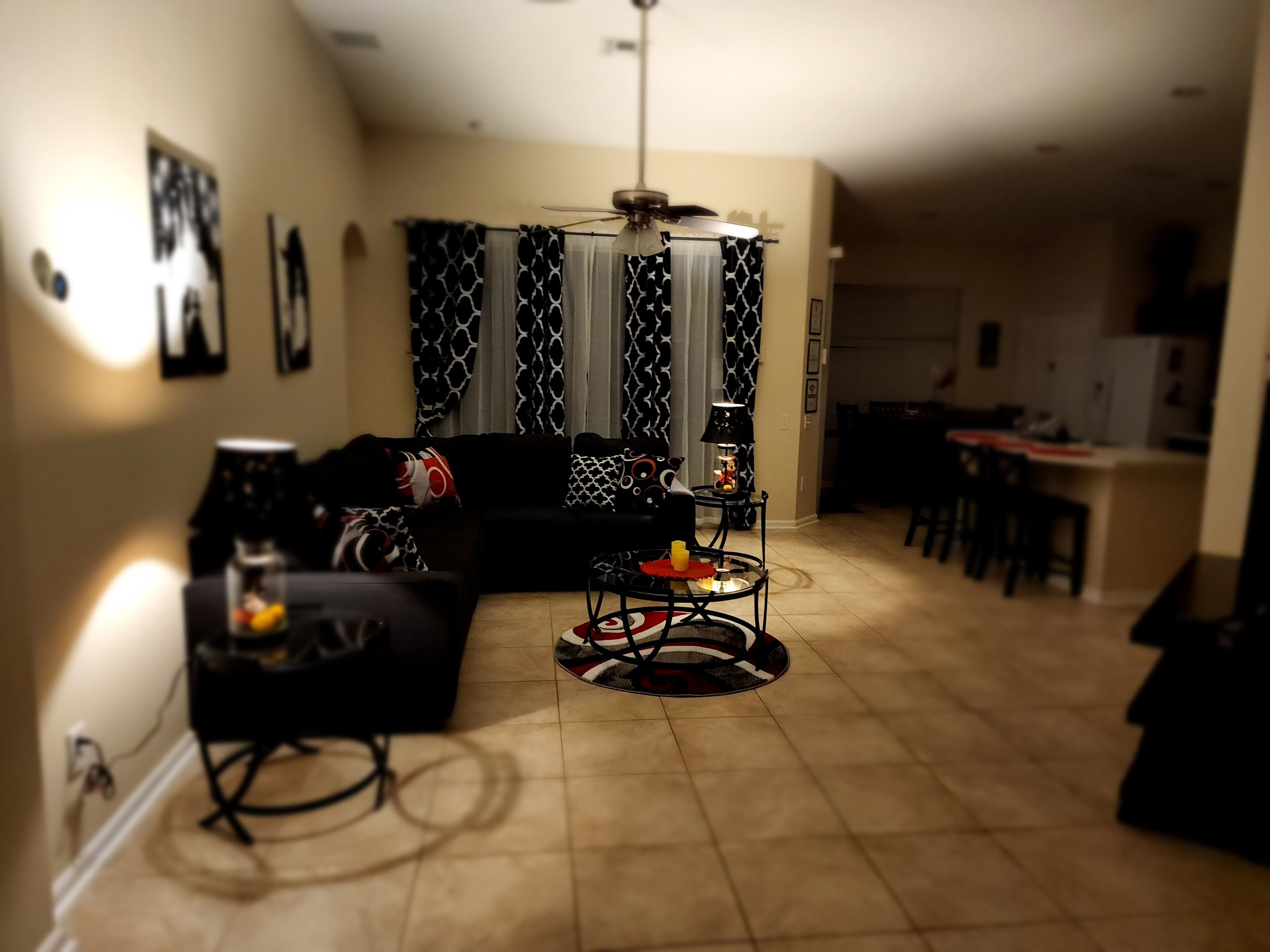 A living room with a sofa, a coffee table, and a dining area with a table and chairs.