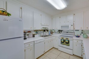 Enjoy cooking in this well-equipped kitchen with microwave, dishwasher, and refrigerator.