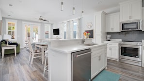 Enjoy cooking in this well-equipped kitchen with a central island, appliances, and ample natural light.
