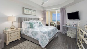 A bedroom with a bed, nightstand, dresser, TV, and a view of the outdoors. - Crescent at Miramar-gulf Front Luxury Condo-free Beach Chairs! (Miramar Beach)