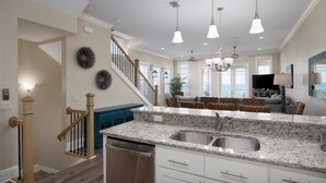 A spacious kitchen with granite countertops, stainless steel sinks, and a dishwasher.