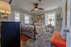 A bedroom with a bed, a ceiling fan, a nightstand, and a window with blinds. - WONDERFUL VACATION OPPORTUNITY, STEPS FROM BEACH, SLEEPS 14 (North Myrtle Beach)