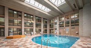 Relax by the pool surrounded by a checkered floor and lounge chairs.