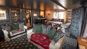 A cozy living room with two sofas, a coffee table, and a dining area with a table and chairs. - Little Gem - Thoughtfully Curated Desert Escape (Tucson)