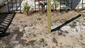 A single-story house with a covered porch, a small patio area, and a wooden fence. - ❤️Dixieland Delight❤️Studio. Pet friendly WITH FEE 🐕🐈❤️❤️❤️❤️❤️ (New Port Richey)