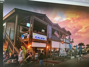 A building with a sign reading "Welcome Home" and "CALEBI" on the storefront.