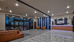 A spacious lobby with a reception desk, seating area, and large windows. - Scenic View Inn & Suites Moab (Moab)