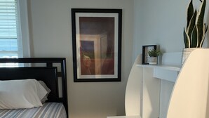 A modern bedroom with a bed, a desk, and a chair.