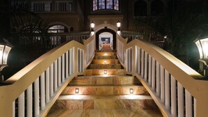 A grand staircase with a balustrade, leading to an upper level.