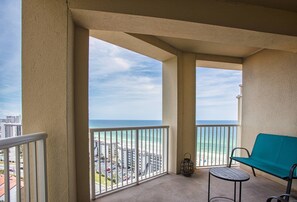 Enjoy the ocean view from this balcony with a clear view of the beach and cityscape.