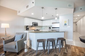 Enjoy cooking in this well-equipped kitchen with a central island, microwave, oven, and coffee maker.