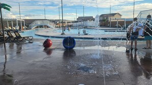 A public water feature with multiple fountains and a pool area. - Pool now open! Pickleball! Game Room! (Washington)