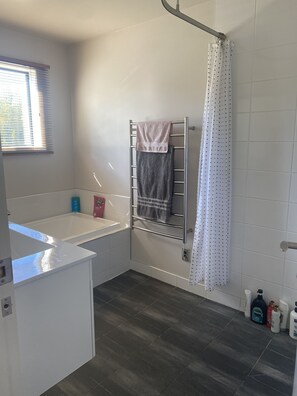 Bathtub, hair dryer, towels, soap