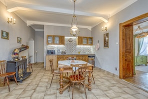Enjoy meals in this dining area with a large round table and stove.