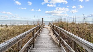 A wooden boardwalk leading to a beach with a clear sky and clouds. - 2877 - Carolina Dreamin - Oceanfront Duck Escape w/ Hot Tub & Views (Kitty Hawk)