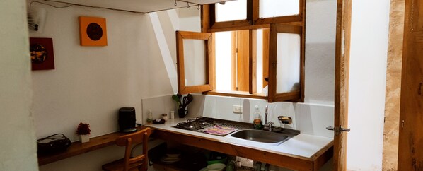 Enjoy cooking in this kitchen with a gas stove and ample storage for utensils and dishes.