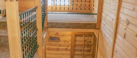 A wooden interior with a staircase leading to an upper level.