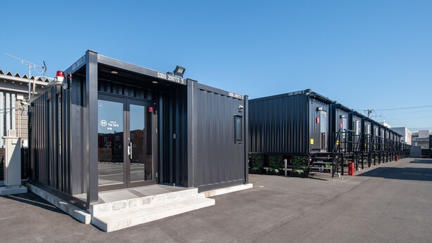 A modern building with a glass entrance and metal exterior, featuring a sign with "CODO 20072" and "CODO 20073". - HOTEL R9 The Yard Kamisu (Kamisu)