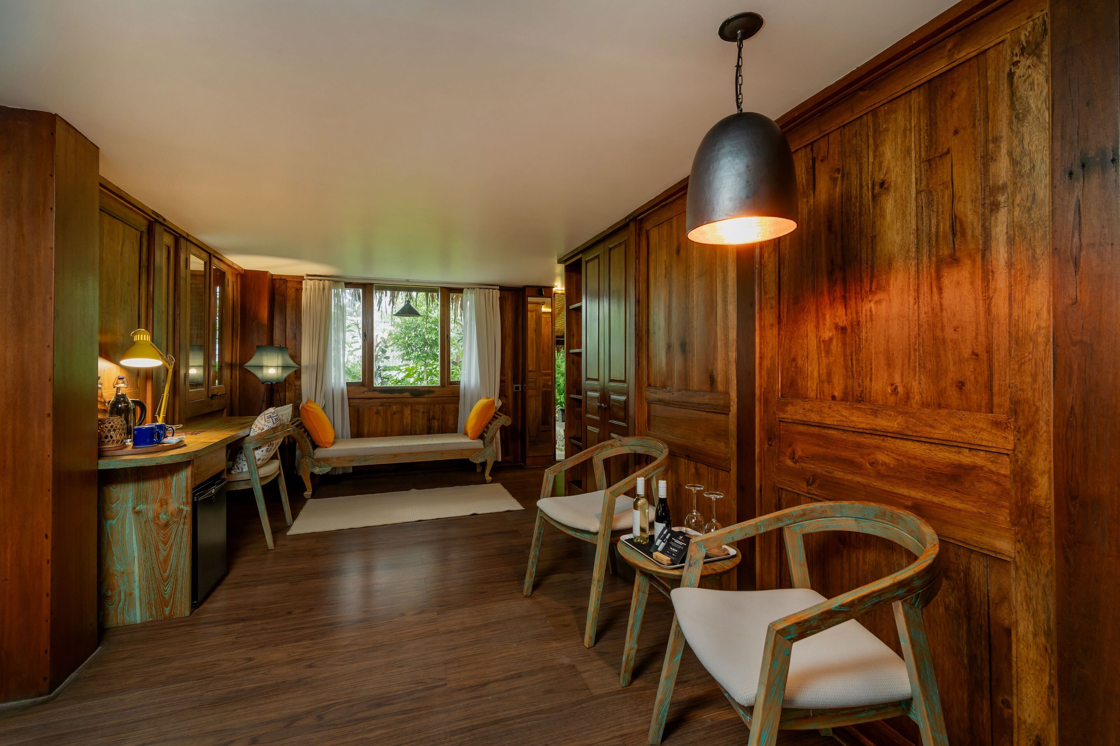 A wooden interior with a dining area, wooden walls, and a bench.