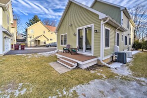 A two-story house with a covered porch, a front door, and a visible garage. - Stunning House w/ Deck, Game Room & Home Gym! (Saratoga Springs)