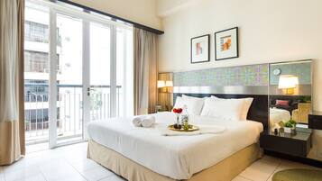 Desk, iron/ironing board, bed sheets